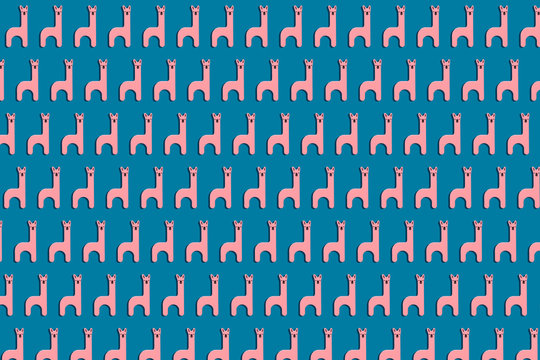 Cute pink llamas wooden toy in a row on blue background