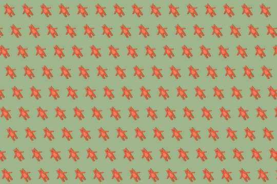 Brown bears, wooden toy in a row holding hands on a khaki green background