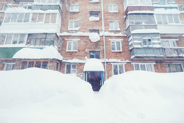 Heavy snowfall, house swept by snow on  winter day