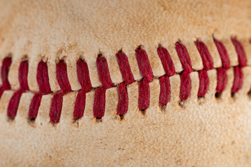 Fototapeta na wymiar Closeup of old, dirty baseball with red seams.