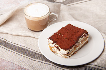 Tasty piece of tiramisu with cup of coffee. Homemade tiramisu with cappuccino.
