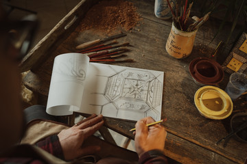 Craftsman decorates handmade terracotta