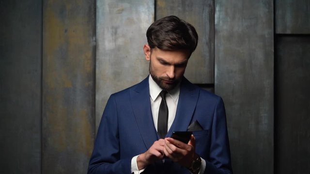 full hd video of young handsome stylish businessman using smartphone - 4x slow motion