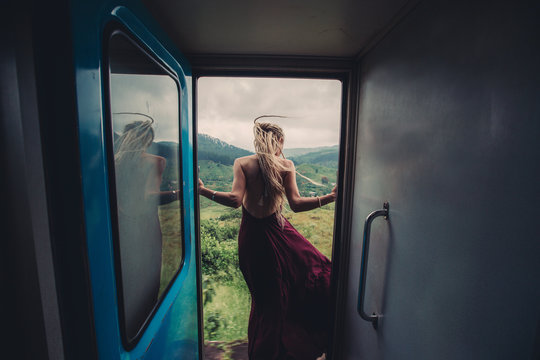 Female wearing beautiful dress travel by train in Sri Lanka