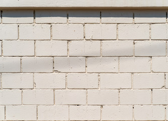 White-Cream Cement wall with brick pattern at outdoor field for background.