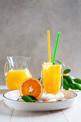 Natural freshly squeezed orange juice with ice and mint in a glass © Eleonora