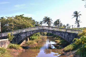 a small bridge over a channel in goa India