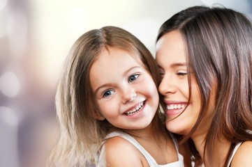 Happy Mother and daughter hugging on blur background