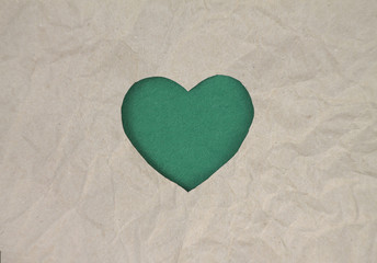 Green felt heart on craft paper. Crumpled paper texture. Valentine's day stock photo for web, print...