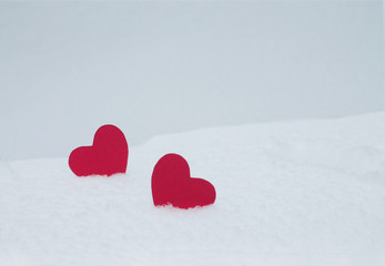 Two red felt hearts on the snow. Handmade for the celebration and holiday. Stock Photography for...