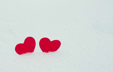 Two red felt hearts on the snow. Handmade for the celebration and holiday. Stock Photography for Valentine's Day with empty space for your text. For web, print, cards, invitations and wallpapers.