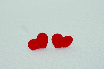 Two red felt hearts on the snow. Handmade for the celebration and holiday. Stock Photography for...
