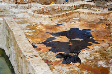 Leather drying near stone vats in Tannery of Tetouan Medina. Northern Morocco.