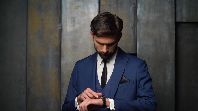 full hd video of young handsome stylish businessman - 4x slow motion - looking at watch
