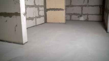 Ready concrete mix for sludge for floor construction and leveling material. Ready floor level in the apartment. Freshly made floor level with mortar.