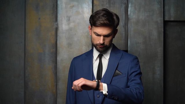 full hd video of young handsome stylish businessman - 4x slow motion - looking at watch