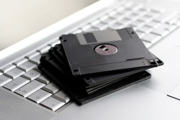 Old floppy disks on a silver keyboard