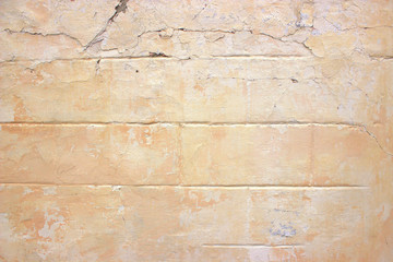 Texture of the yellow wall covering of an old house