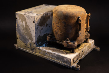 Damaged Aircraft flight data recorder on black background. Black Box with extensive fire damage after an accident or production testing of equipment