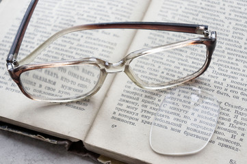 Broken glasses on the book