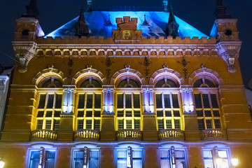 Fototapeta na wymiar Night winter view of the Artus Court in Torun, Poland. The building was designed by Rudolph Schmidt in neo-renaissance and historicism styles and built between 1889 and 1891.