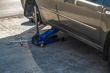 Replacing a wheel on a car. Car lifted on a jack for wheel repair.