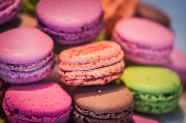 Fototapeta na wymiar mix french macaroons close up view with different flavours & colours