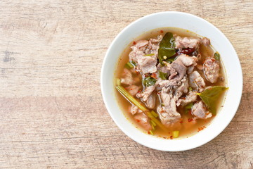 hot and spicy pork belly with tamarind and Thai herbs soup on bowl 