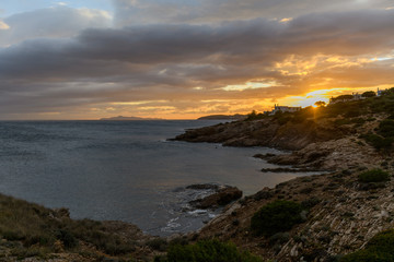 Beautiful rocky coastline and blue sea at sunset