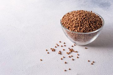  healthy buckwheat in a bowl isolated on gray background close-up with place for text