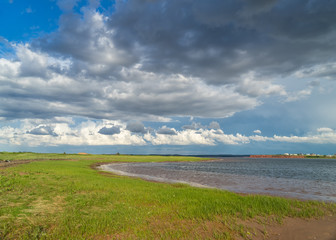 Waves lapping up along the beach on the shores of rural Prince Edward Island, Canada.