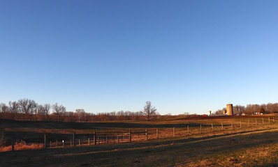 Obraz premium Farm Acres Lit by Sunset