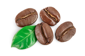 roasted coffee beans with leaves isolated on white background with clipping path and full depth of field. Top view. Flat lay.