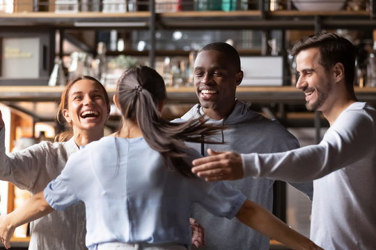 Happy Diverse Friends Giving Hug Meeting Girlfriend In Cafe