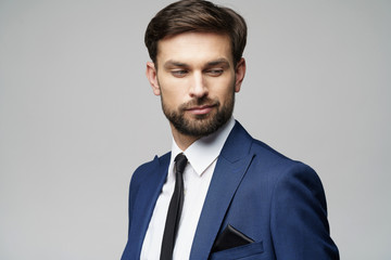 studio photo of young handsome stylish businessman wearing suit