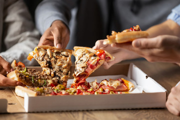 Obraz na płótnie Canvas Close up of multiethnic friends share delicious pizza