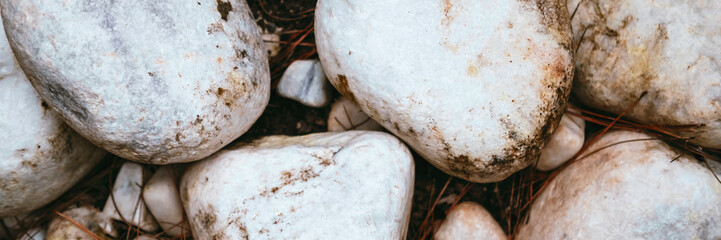 Banner of pattern large white stones on ground. Stone background. Rock texture.