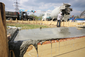 Fill the foundation of the house, garage. The work of construction workers.