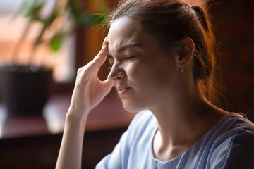 Young woman feel unwell suffering from strong headache
