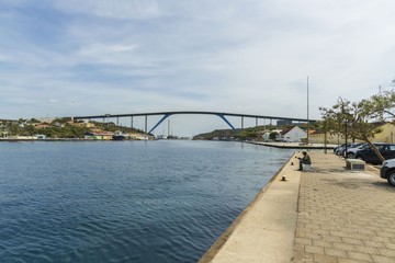 Beautiful view of famous Queen Juliana Bridge. Gorgeous ocean landscape on blue sky background. Willemstad. Curacao. 