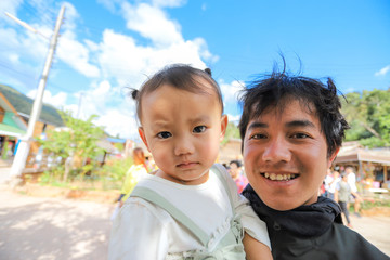 Man carrying his lovely baby daughter on beautiful sunny day