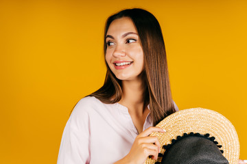 looking sideways, the girl is very cute and friendly. background yellow