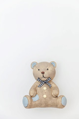 Simply minimal design with toy bear isolated on white background. Children care materinity family concept. Flat lay, top view, copy space