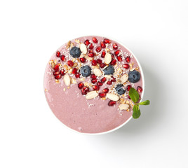 Breakfast smoothie bowl with yogurt, blueberries, pomegranate, almonds and mint. Healthy breakfast