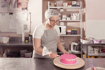 woman pastry chef prepares and decorates cake 