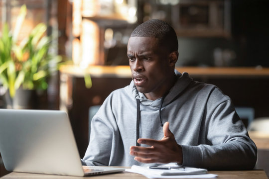 Angry black guy having laptop software problems