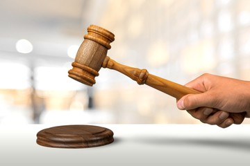 Book and wooden gavel on table. Justice concept