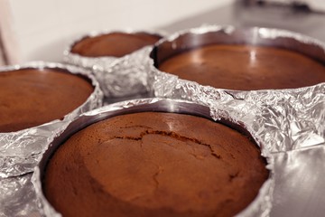 few sponge bakes in foil and shape on the table and just from the oven