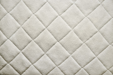 The texture of the material, fabric. Background from white, beige pattern material.
