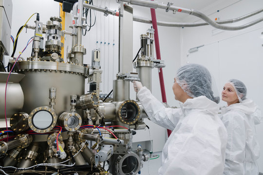 Laboratory technicians working on a device in laboratory of science center